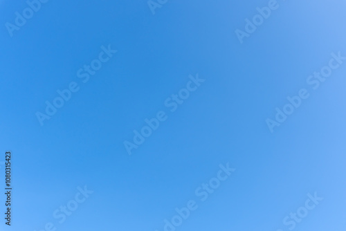 Low angle view and full frame of beautiful blue sky without clouds in the morning or evening used as natural background texture in decorative art work