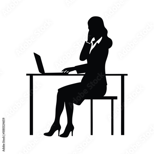 A woman is sitting at a desk with a laptop. She is talking on the phone