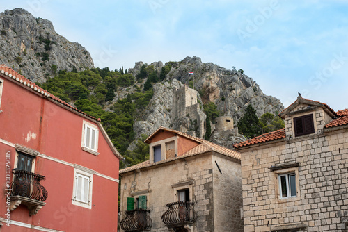 Fortress Peovica (Mirabela) overlooks Omis, Croatia, offering scenic views of the town, sea, and nearby mountains. photo