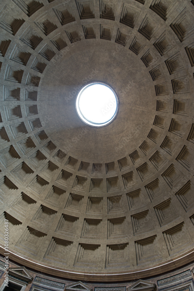 View of the iconic oculus in the Pantheon dome, Rome, showcasing its architectural grandeur and intricate design. View of the iconic oculus in the Pantheon dome, Rome, showcasing its architectural grandeur and intricate design.