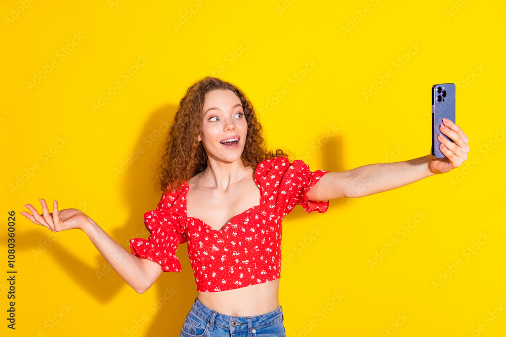 Photo of attractive young woman selfie photo point empty space amazed dressed stylish red clothes isolated on yellow color background Photo of attractive young woman selfie photo point empty space amazed dressed stylish red clothes isolated on yellow color background