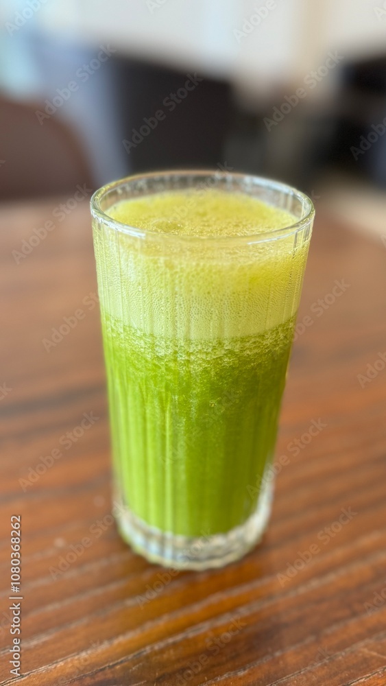 Green healthy juice on a table in a cafe Green healthy juice on a table in a cafe