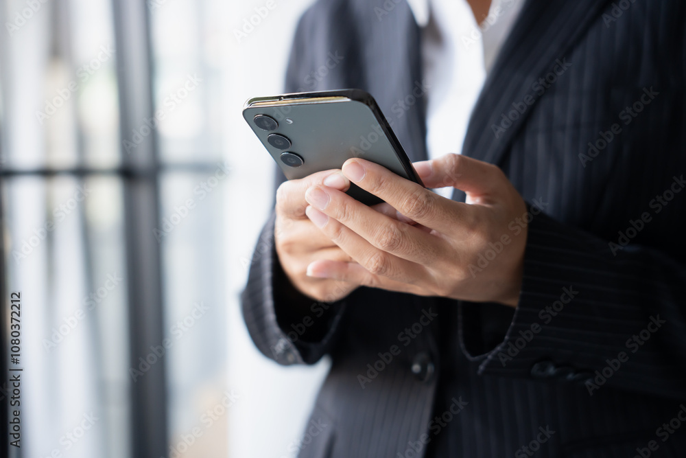 Asian Business woman using smart phone spending time checking news social media Asian Business woman using smart phone spending time checking news social media