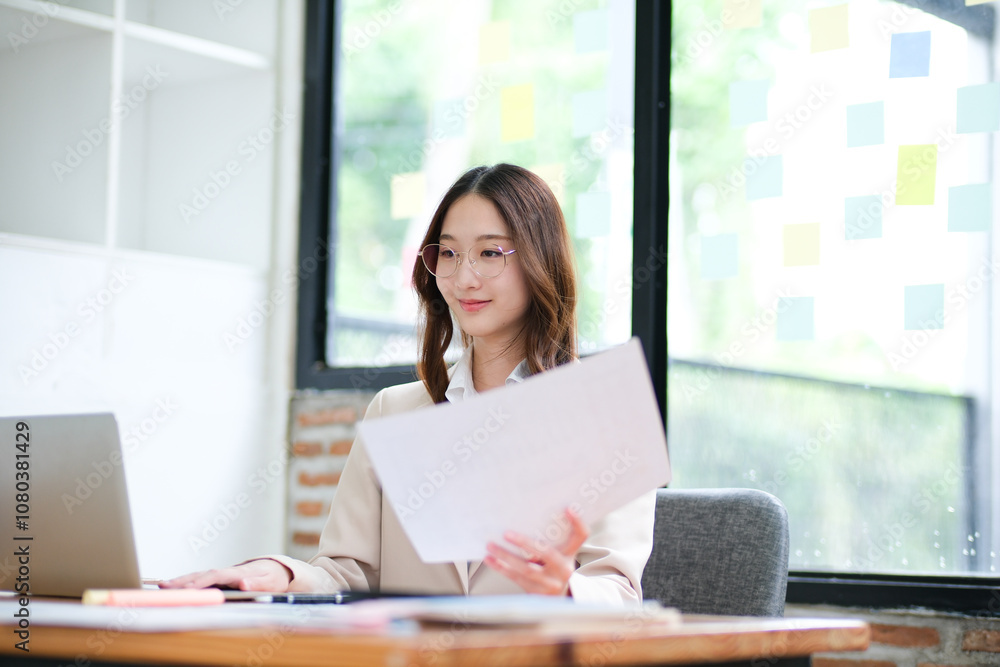 Businesswoman analyzing financial data and managing online investments Businesswoman analyzing financial data and managing online investments