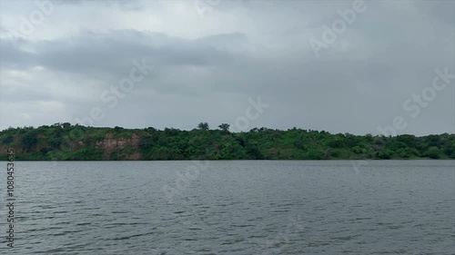 Stunning view of water flowing with wind in Mahisagar river under cloudy monsoon sky in India, beauty of nature during rainy season. photo