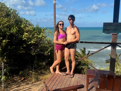 casal de turistas na praia do amor  photo