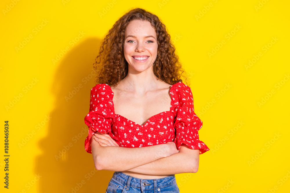 Photo portrait of attractive young woman crossed hands confident dressed stylish red clothes isolated on yellow color background Photo portrait of attractive young woman crossed hands confident dressed stylish red clothes isolated on yellow color background