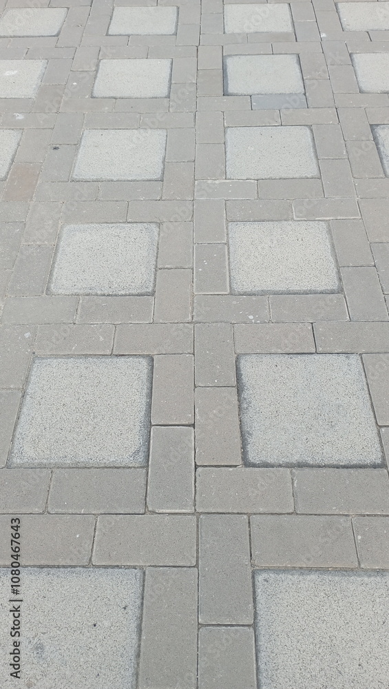 Obraz premium Grey concrete tiles in a grid pattern.