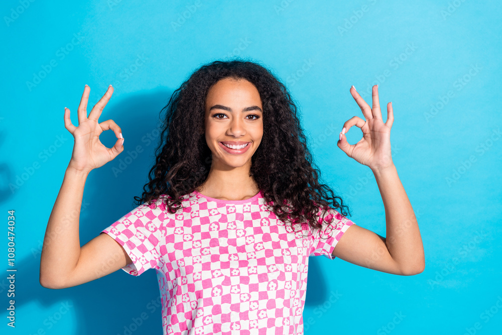 Photo of shiny attractive lady dressed pink t-shirt showing two okey signs empty space isolated blue color background Photo of shiny attractive lady dressed pink t-shirt showing two okey signs empty space isolated blue color background