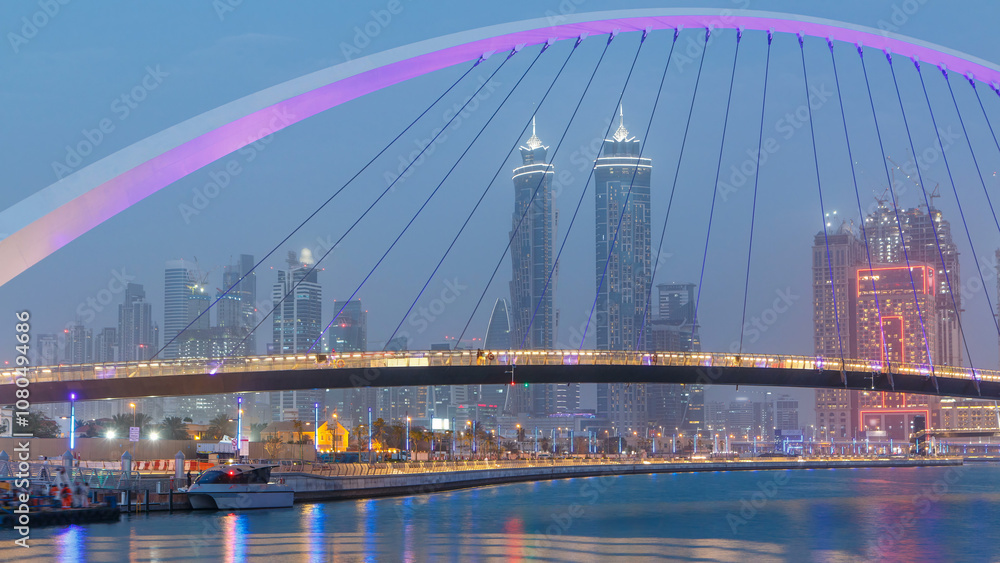 Obraz premium Pedestrian Bridge over the Dubai Water Canal day to night timelapse, United Arab Emirates