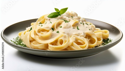 a plate of fettuccine pasta with alfredo sauce isolated on a white background highlighting a creamy italian dish