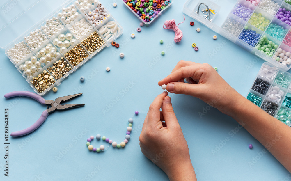 Creating colorful beaded jewelry with vibrant materials on a crafting table Creating colorful beaded jewelry with vibrant materials on a crafting table