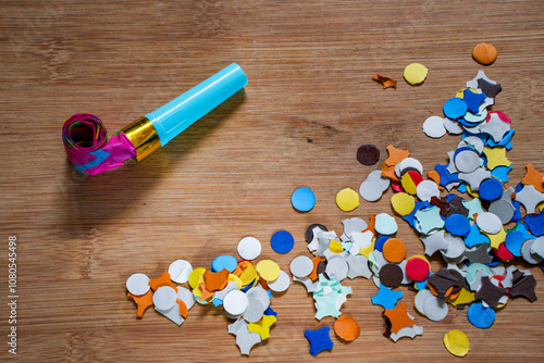 Party horns on colorful confetti stillife