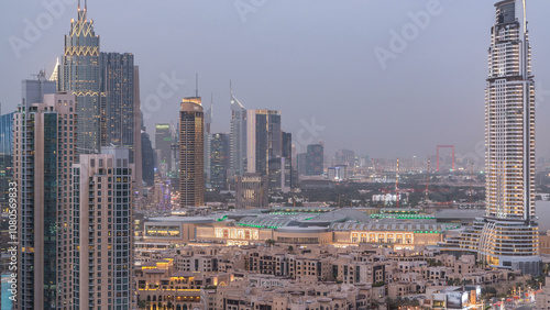 Dubai Downtown day to night timelapse. Aerial view over big futuristic city by night. photo