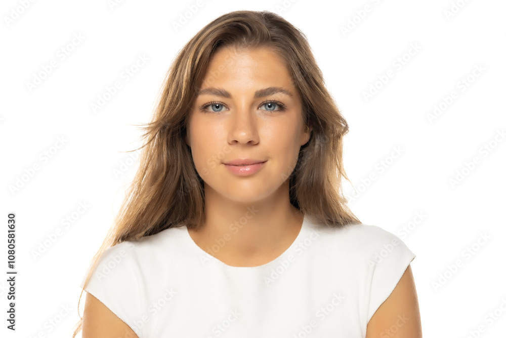 Portrait of young smiling woman with a light makeup on a white studio background. Portrait of young smiling woman with a light makeup on a white studio background.