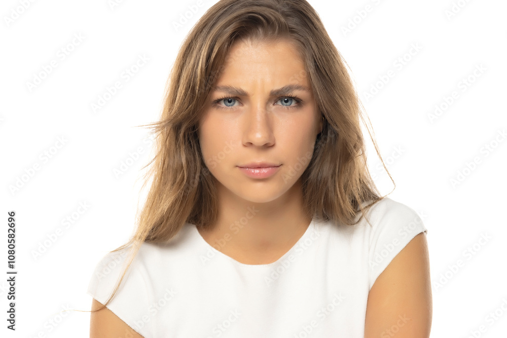 Portrait of young uncertainty woman with a light makeup on a white studio background Portrait of young uncertainty woman with a light makeup on a white studio background