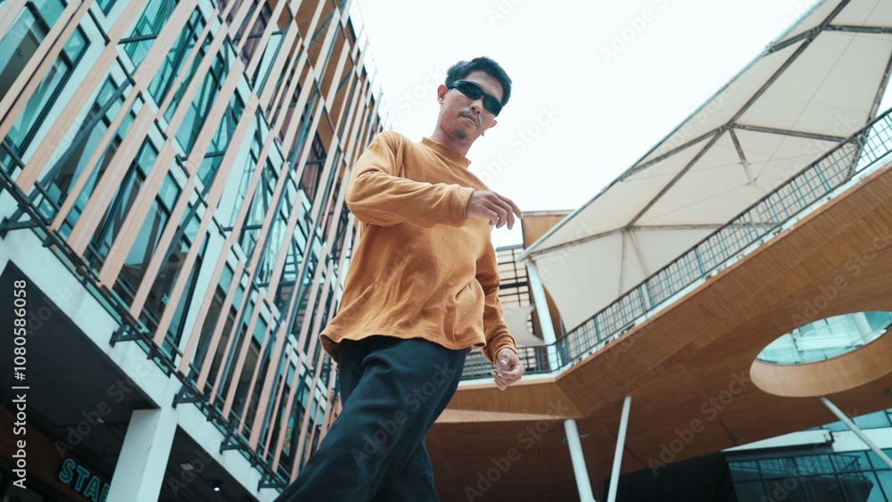 Hispanic dancer looking at camera while dancing in hip hop style. Young attractive hipster moving and dancing to music. Motion shot of break dancer perform b-boy dance Outdoor sport 2024. Hiphop. Hispanic dancer looking at camera while dancing in hip hop style. Young attractive hipster moving and dancing to music. Motion shot of break dancer perform b-boy dance Outdoor sport 2024. Hiphop.