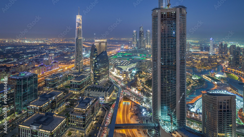 Obraz premium Dubai Downtown day to night timelapse modern towers panoramic view from the top in Dubai, United Arab Emirates.