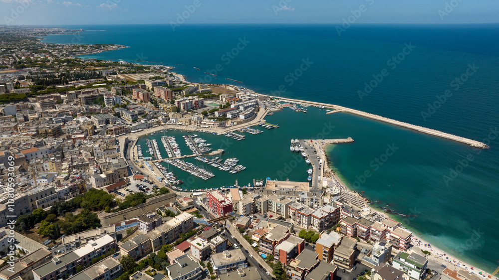 Aerial view of the historic center of Bisceglie, in Puglia, Italy. In the foreground is the tourist port, with many boats anchored, located on the Mediterranean Sea. Aerial view of the historic center of Bisceglie, in Puglia, Italy. In the foreground is the tourist port, with many boats anchored, located on the Mediterranean Sea.