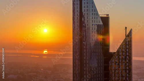 Photography Sunrise over Dubai skyline in the morning, aerial top view to downtown city center landmarks timelapse