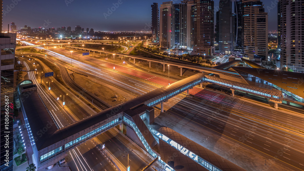 Obraz premium Aerial top view to Sheikh Zayed road near Dubai Marina and JLT night to day timelapse, Dubai.