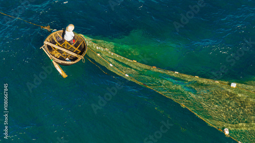 Fishermen spread nets to catch fish at Chan May beach, Hue, in the middle of the vast sea and the turquoise water is truly beautiful. Photo taken in Hue on June 25, 2023.