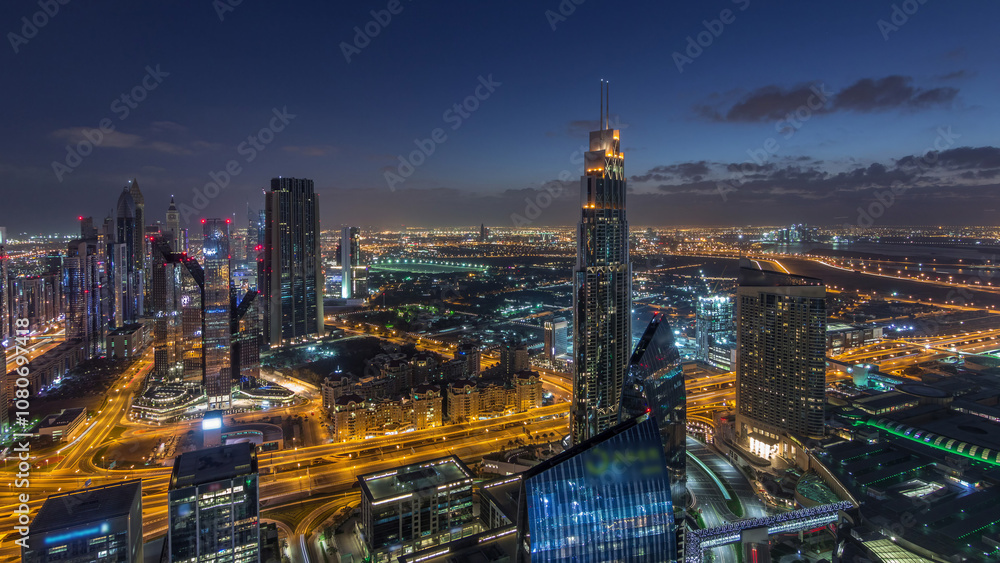Fototapeta premium Dubai International Financial Centre district with modern skyscrapers night to day timelapse