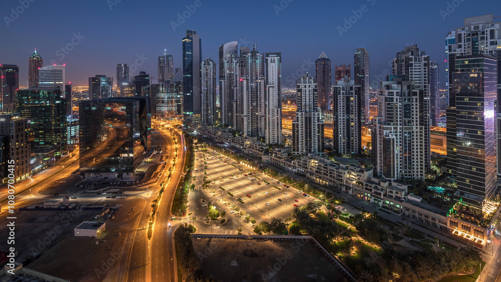 Obraz premium Panorama of Business bay Dubai night to day aerial timelapse.