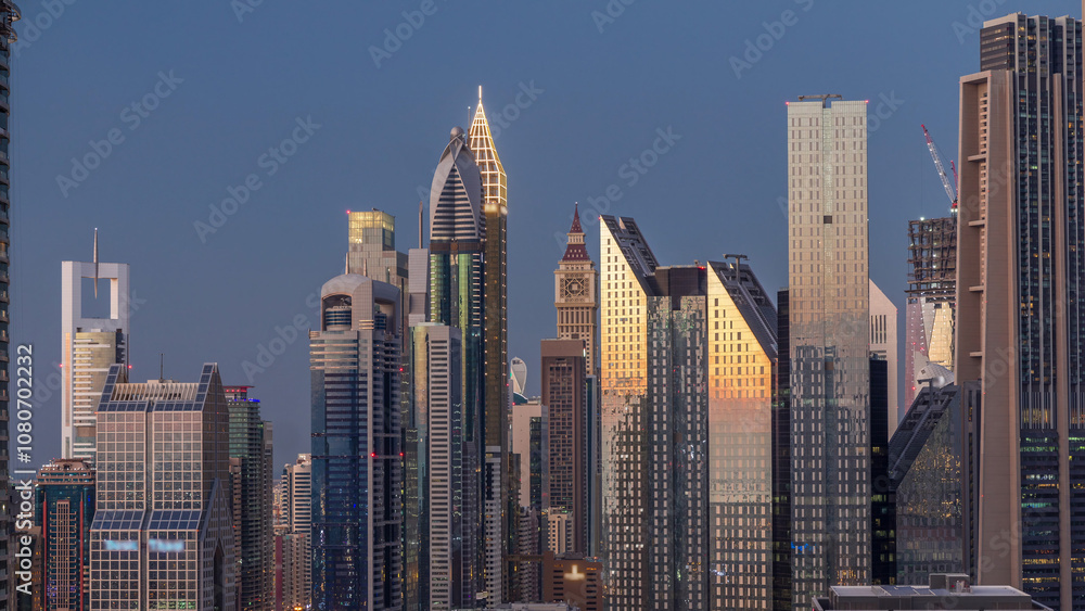 Obraz premium Aerial view of new skyscrapers and tall buildings in Dubai day to night timelapse