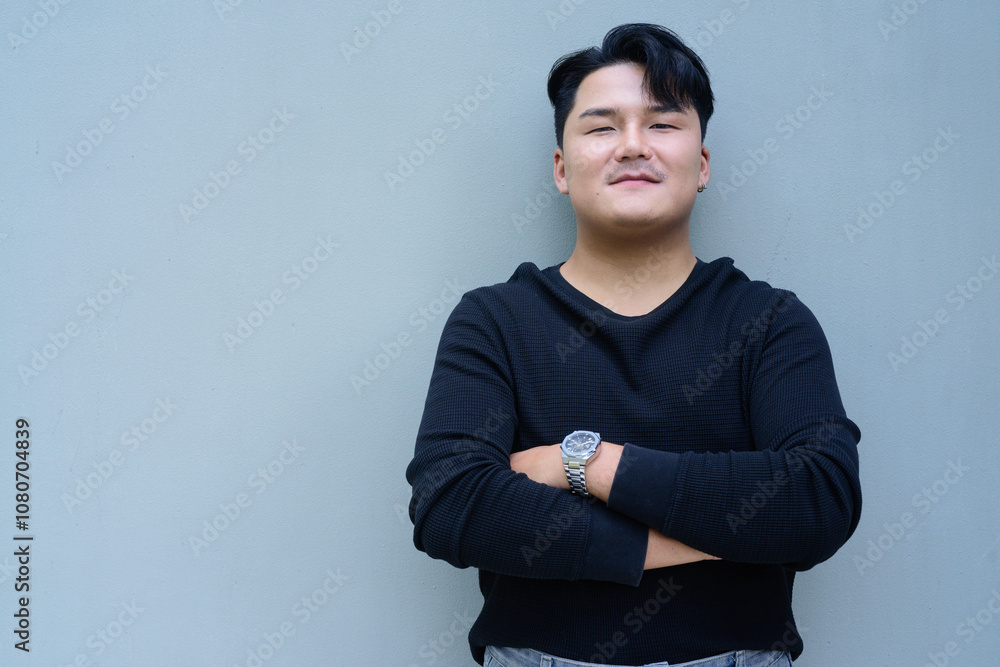 Portrait of Handsome Young Asian Man Against Plain Background Outdoors Portrait of Handsome Young Asian Man Against Plain Background Outdoors