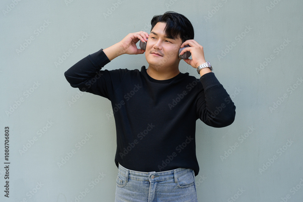 Portrait of Handsome Young Asian Man Against Plain Background Outdoors Portrait of Handsome Young Asian Man Against Plain Background Outdoors