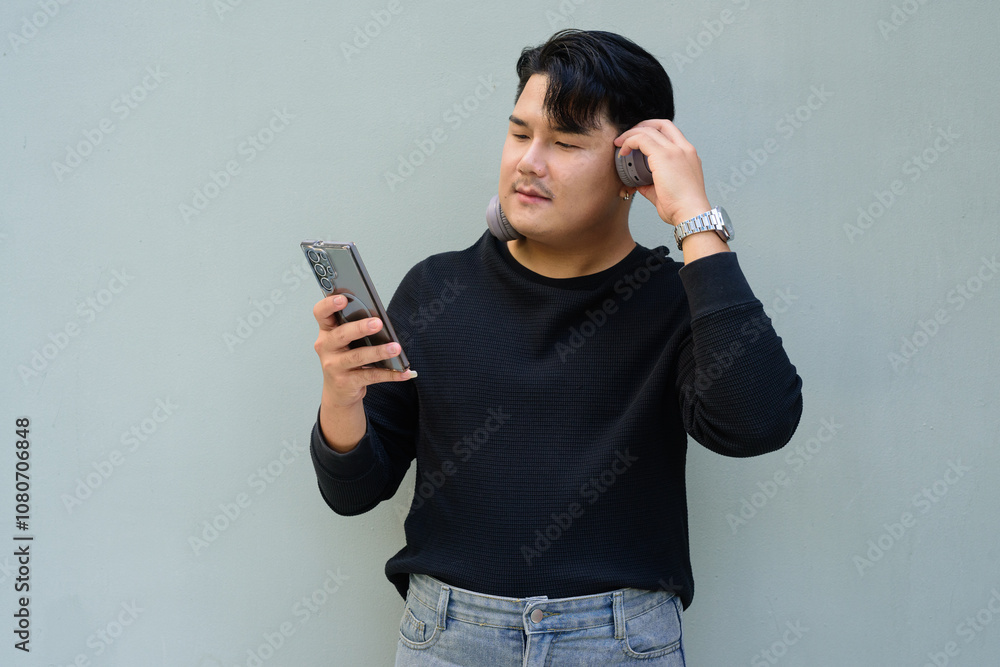 Portrait of Handsome Young Asian Man Against Plain Background Outdoors Portrait of Handsome Young Asian Man Against Plain Background Outdoors