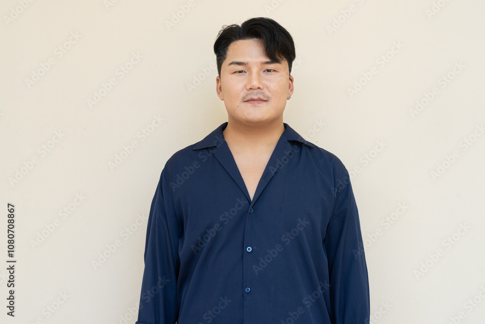 Portrait of Handsome Young Asian Man Against Plain Background Portrait of Handsome Young Asian Man Against Plain Background