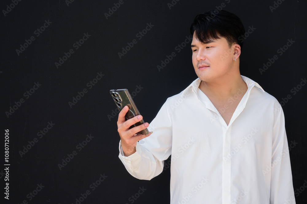Portrait of Handsome Young Asian Man Against Black Background Portrait of Handsome Young Asian Man Against Black Background