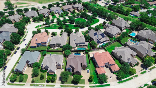 Cul-de-sac keyhole shape dead-end street in upscale residential neighborhood colorful concrete roof tiles on row of large two-story suburban mansion single-family houses Coppell, Texas, aerial photo