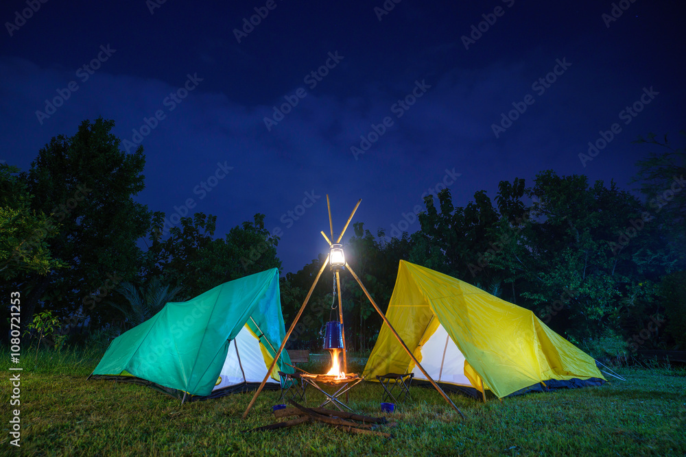 camping tent in the forest with green trees, camping in the forest at night, Small gas lantern on green grass camping tent in the forest with green trees, camping in the forest at night, Small gas lantern on green grass