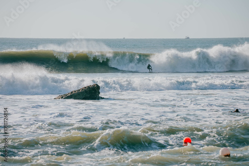 Photography Cinematic shot of the person surfing on at huge wave