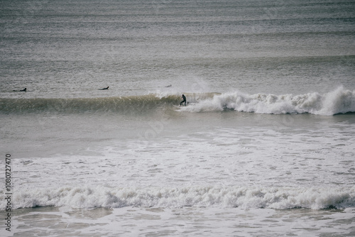 Waves in the sea and people surfing on the waves