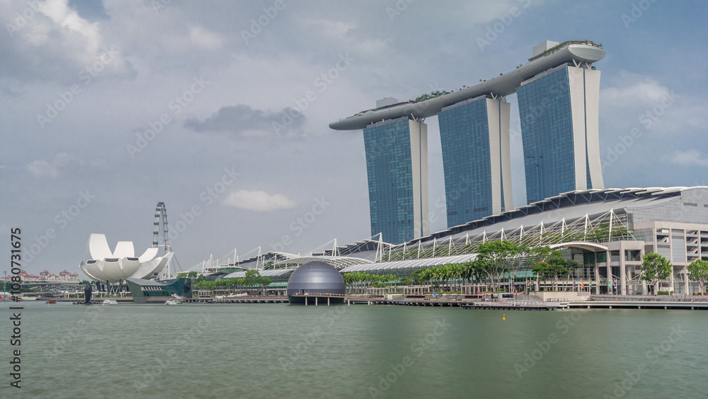 Naklejka premium Fifty-five storeys high Marina Bay Sands Hotel dominates the skyline at Marina Bay in Singapore timelapse hyperlapse.