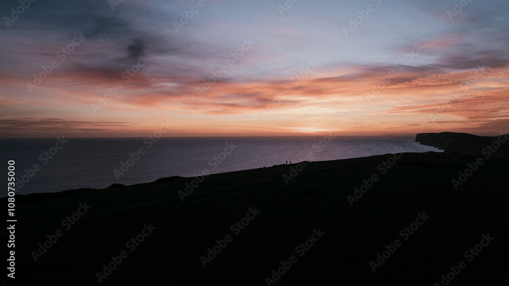 Evening view of the sea and an island in the dark and only the sky is shining Evening view of the sea and an island in the dark and only the sky is shining