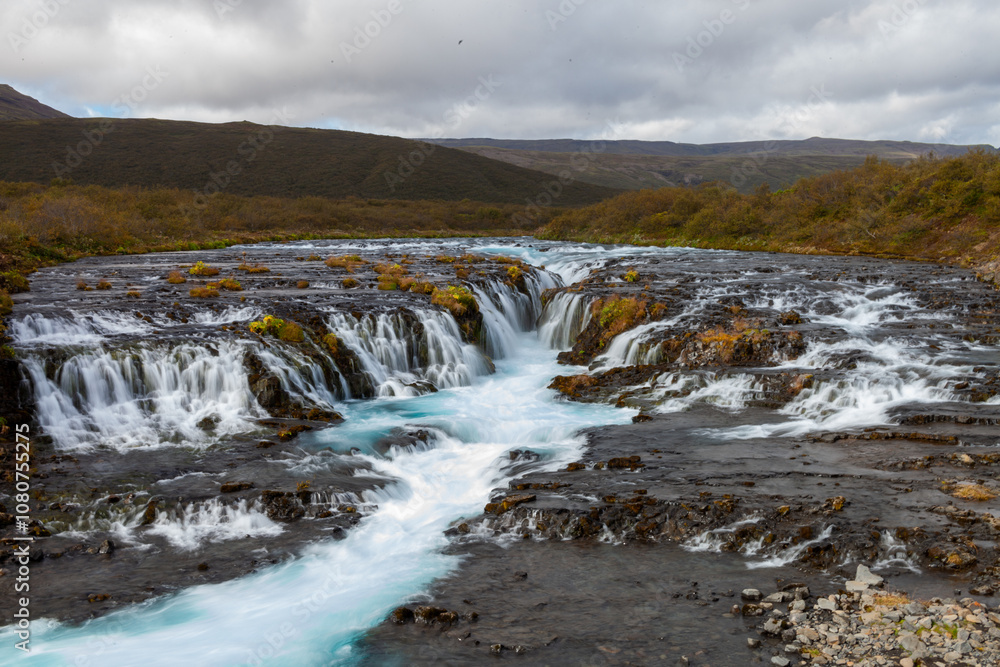 Wide Waterfall in Iceland with Blue Water Wide Waterfall in Iceland with Blue Water