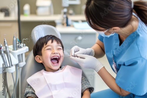 Laughing Japanese girl at dentist with mother, early dental checkup