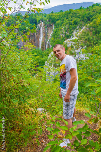 Male tourist traveler at the waterfall and river Plitvice Croatia. photo