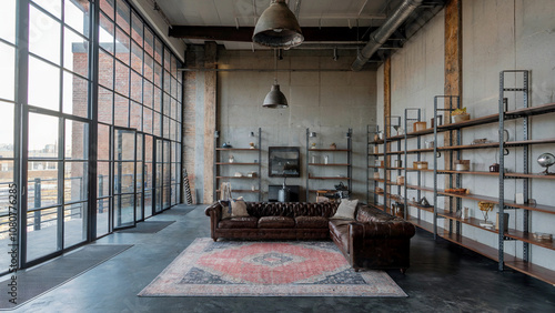 Spacious Industrial Loft with Leather Sofa, Open Shelving, and Large Windows
