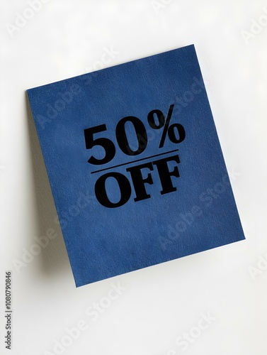 Black '50% OFF' Text on a Navy Blue Square Paper Note. White Background 