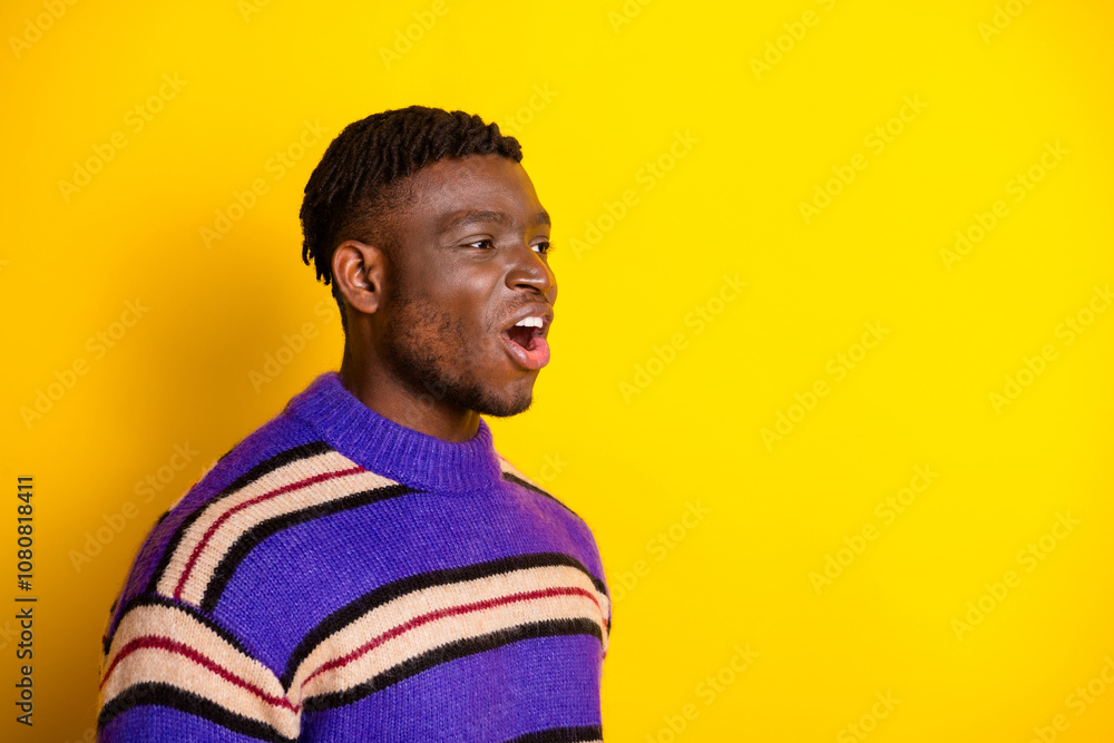Profile photo of nice young man open mouth empty space wear pullover isolated on yellow color background Profile photo of nice young man open mouth empty space wear pullover isolated on yellow color background