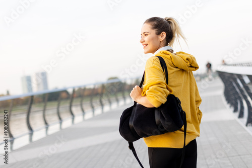 A joyful woman strolls alon...