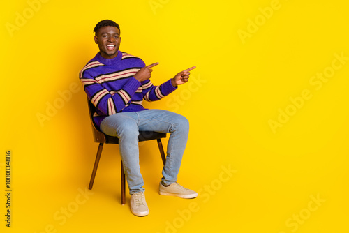 Full size photo of nice young man direct fingers empty space isolated on yellow color background