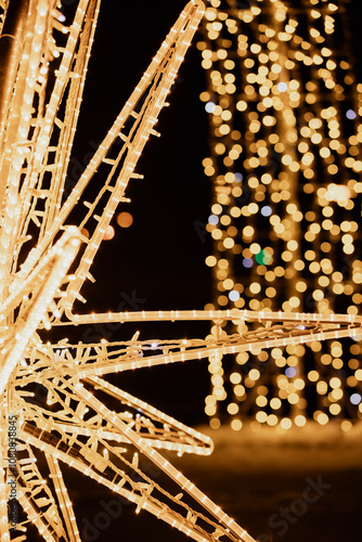 golden glowing christmas lights with bokeh and dark background