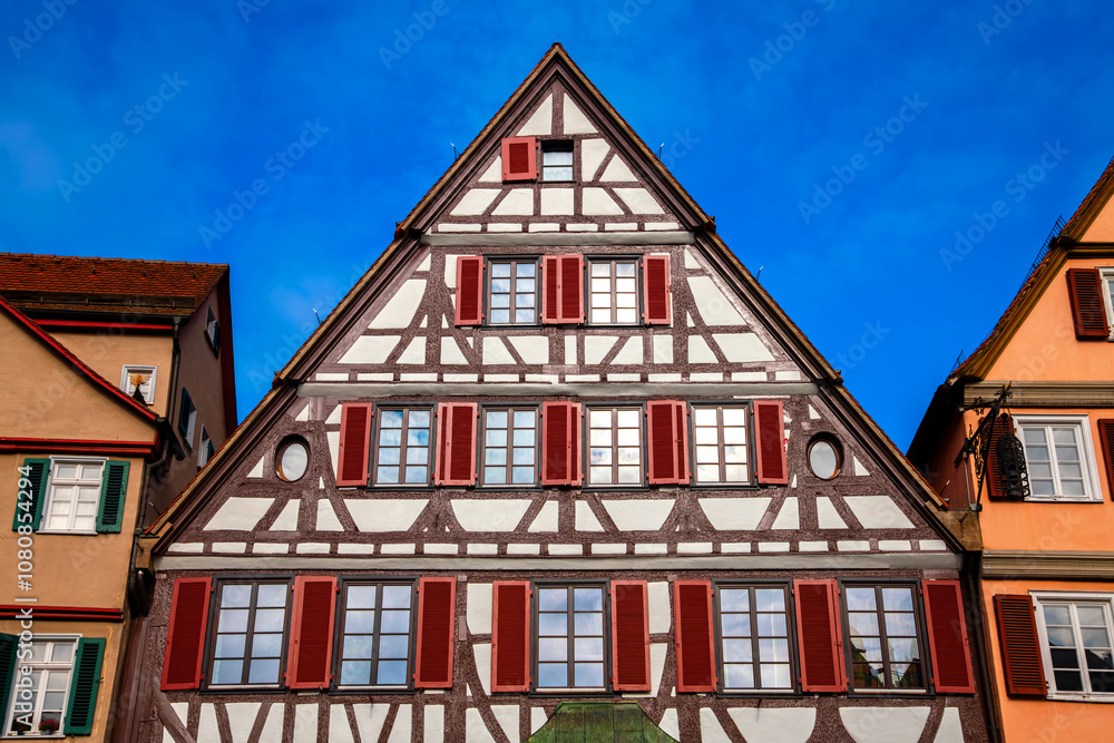 Historic half-timbered gable facade on the market square in Tübingen, a university city in Germany. Colorful truss house in the picturesque, lively swabian old town. Symmetrical frontal view. Historic half-timbered gable facade on the market square in Tübingen, a university city in Germany. Colorful truss house in the picturesque, lively swabian old town. Symmetrical frontal view.